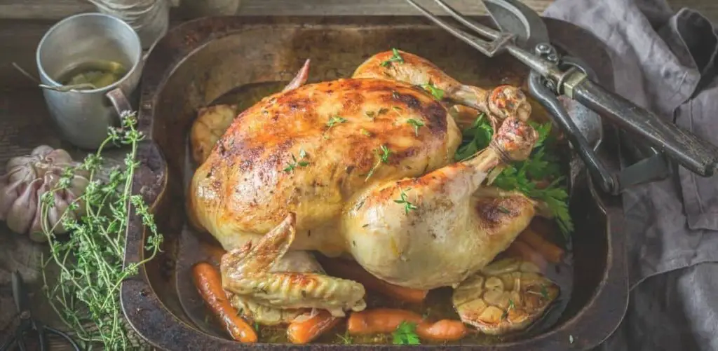 roasted whole chicken in roasting pan